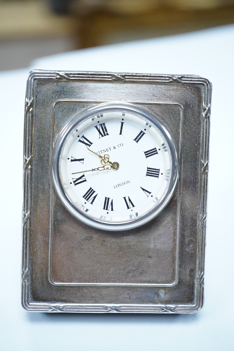 A group of assorted silver, to include a pair of modern five bar toast racks, a George V card case, a sterling vesta case, four assorted condiments, two mounted toilet bottles, mounted timepiece, a modern wooden handled